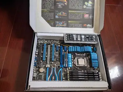 Selling a used Asus P8P67 Deluxe motherboard that comes with an Intel i7-2600K CPU and 16GB of Hyper...
