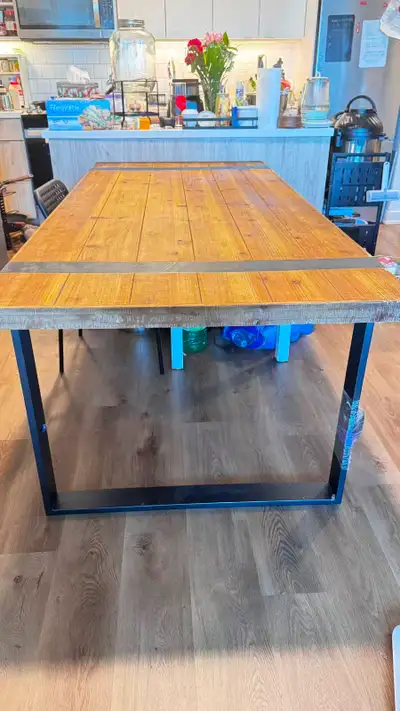 This stylish Structube dining table measures 200 cm by 90 cm and features a rustic wood tabletop wit...