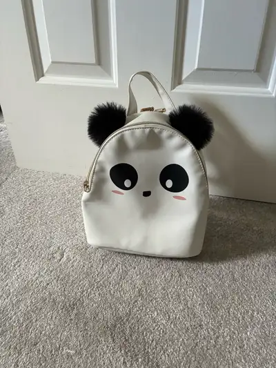 Panda black and white mini backpack in great condition. Zip to close with pockets on the inside.
