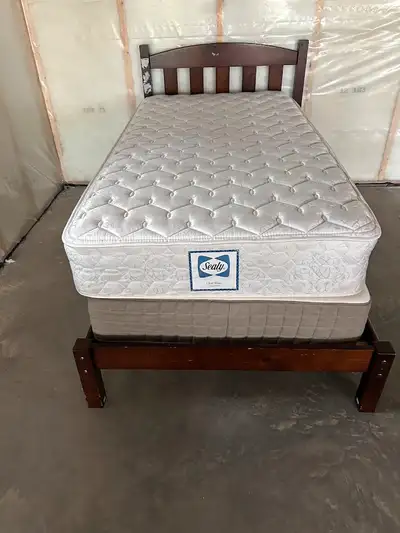 Twin bed and Mattress in good condition. Only the Sealy mattress is included in this sale. It can be...