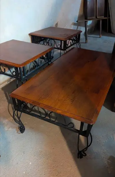 Set of 3 coffee tables. Wood with iron legs. Sturdy and in great shape. Small ones 22 by 22 inch Lar...