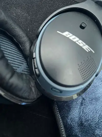 Comfortable Bose over-ear headphones. Black and gray color. Has a matching carrying case. Cash and c...