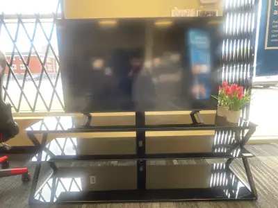 This is a TV with a mount and glass stand, perfect for any living room or entertainment area. If the...