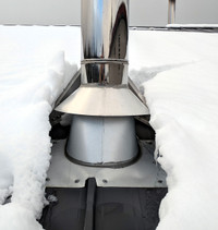Snow divider for woodstove chimney