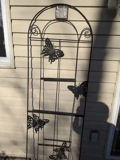 Add a touch of whimsy to your garden with this used metal butterfly trellis, perfect for climbing pl...