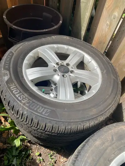 Up for grabs is a set of four Bridgestone Alenza tires, sized at 265/60R18, mounted on stylish Merce...