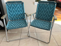 2 blue folding lawn chairs