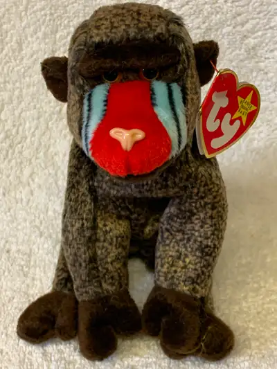 Ty CHEEKS the Baboon is speckled dark brown with dark brown hands, feet, ears and eyebrows. It has b...
