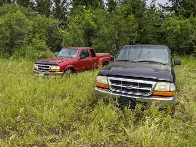 Not running, but do turn over. The red truck has a head gasket issue and the black one has a bent fr...