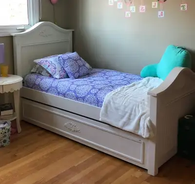 Solid wood white bed with trundle underneath for storage or a second mattress (can used as a spare b...