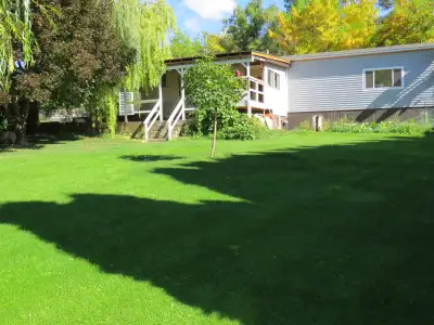 1 1/2 fenced park like acres on the upper level and 6+ acres of lower sub-irrigated field on 1/4 mil...
