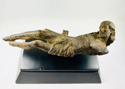 This exquisite wooden crucifix figure, likely crafted around the 17th century, represents Christ in...