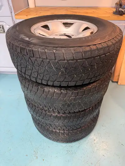 Bridgestone Blizzak snow tires on rims. 245/75/R16 111R on 16” steel rims. Tires still have good tre...