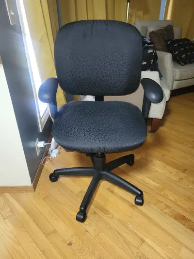 Listed is a fabric office chair with a unique pattern atop the seat.
