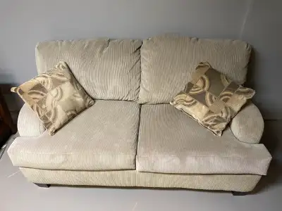 This couch and loveseat set offers comfortable seating with a classic design, perfect for a living r...