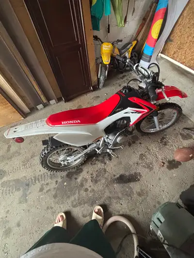Electric Start, kick start, starts and runs good. Could use a back tire soon. Son prefers 4 wheels....
