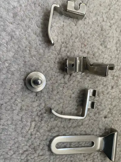 These are a collection of used sewing machine feet in good condition. Perfect for various sewing pro...