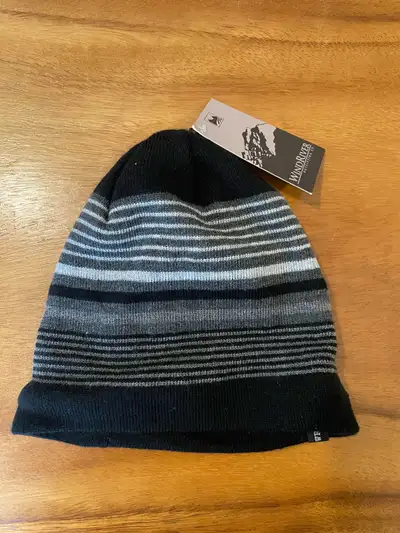 Stay warm with this stylish Wind River toque featuring a striped pattern of black, grey, and white,...