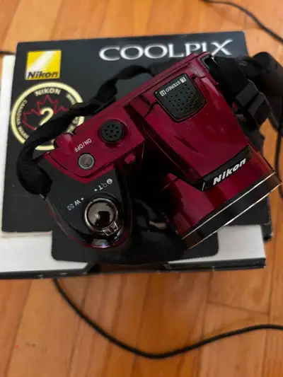 Nikon Coolpox digital camera. Box, manual and Nikon strap. Nikon COOLPIX L120 14.1 MP Digital Camera...