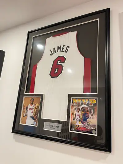 This is a LeBron James Miami Heat signed jersey framed with photos. It is in used, but great, condit...