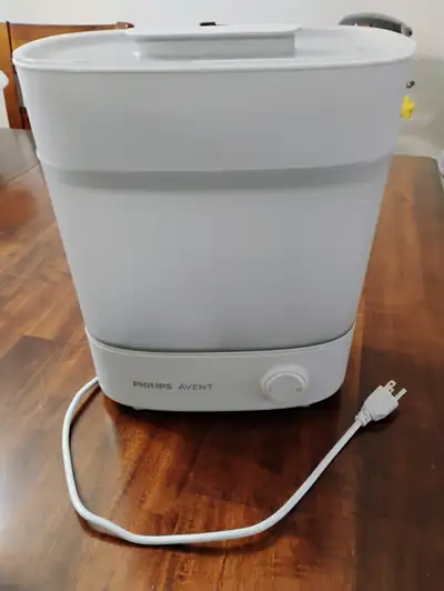 Philips Avent baby bottle steamer/sterilizer. Holds up to six large bottles and caps. It has two tra...
