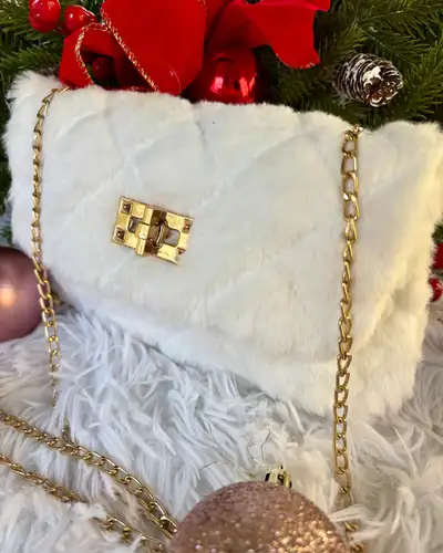 Elevate your style with this chic white faux fur purse, perfect for adding a touch of luxury to any...
