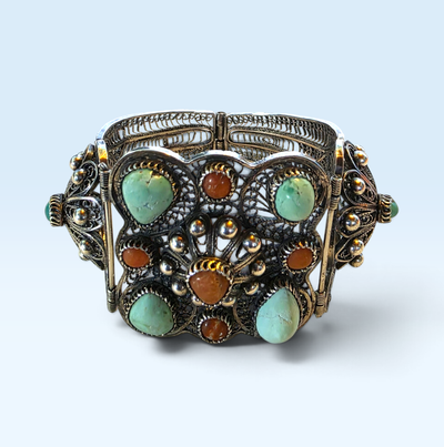 A beautiful and highly detailed example of old Tibetan jewelry craftsmanship, featuring an extraordi...