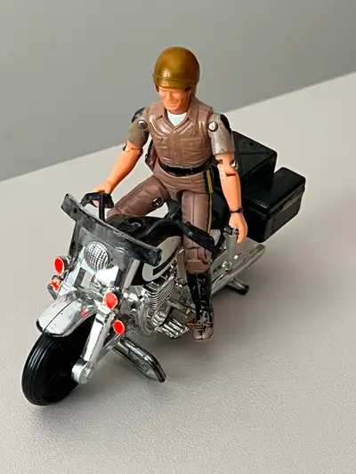 Ponch action figure with helmet and motorcycle from TV series "CHiPs".