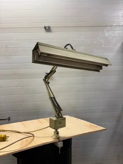 Retro Luxo work light / desk lamp. It works well. Has 2 fluorescent bulbs. Made of metal. It has a c...