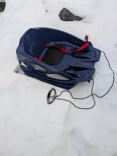 Almost new, blue plastic sled to pull baby on the snow. It has a seatbelt with a clip, and a nice ha...