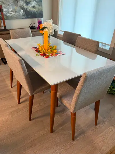 This modern 7 piece dining room set was made in Brazil and includes one glossy white, 63 inch x 35 i...