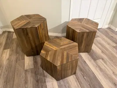 This modern coffee table features a sleek hexagon shape with a walnut wood grain. The set of three t...