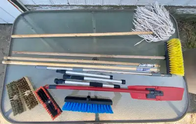 Outdoor garbage bin, assorted mops, scrub brushes and handles