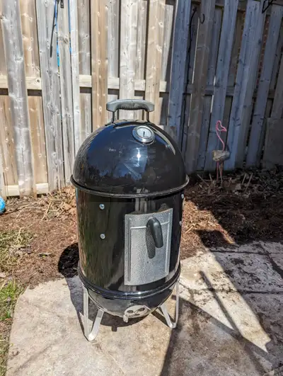 WEBER 14-inch Smokey Mountain Cooker smoker. This smoker features a porcelain-enameled bowl and lid,...