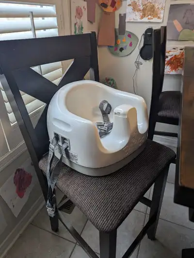 Booster seat straps to any standard chair. Child can sit at the table, or tray attachment may be use...