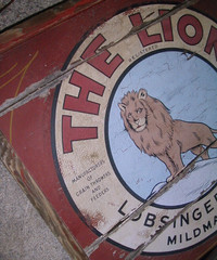 sign - antique The Lion sign from old threshing machine