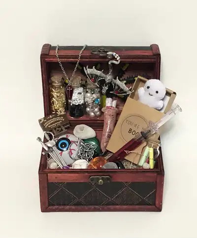 This is a 6x4 inch Treasure Chest full of Spooky/Gothic themed Treasure. There is a mini Ouija board...