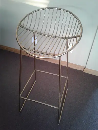 Style is wire frame. Made with durable steel with gold finish. Very stable stool. Compare pricing -...