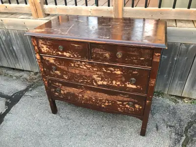 This is an ad for one pre-owned solid wood 4-door dresser. Its in good sturdy and solid condition wi...