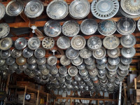 Huge collection of vintage antique hubcaps