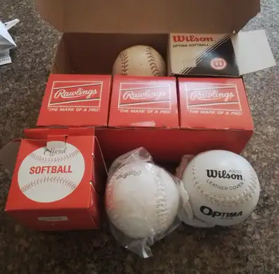 4 brand new, in box, Rawlings softballs, 1 used Rawlings and 1 brand new Wilson softball, in box. Se...
