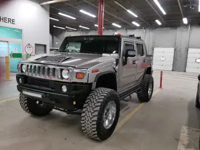 Check out this beast of a 2007 Hummer H2 SUT, lifted and riding high on 40-inch tires, ready to conq...