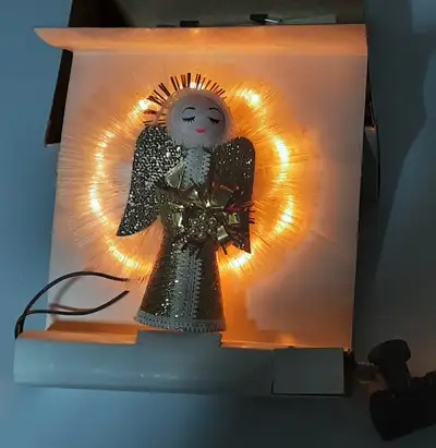 Incandescent lights in fibre optic halo. 6 inch tall. Angel is in excellent like new condition and w...