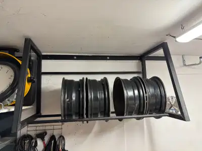 Wall mount Tire rack, that should be secured to studs. Steel, joint are welded has a bit of white pa...