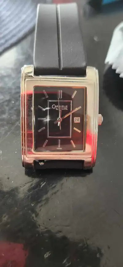 I'm selling a Caravelle by Bulova men's tank watch with a date window. This stylish timepiece featur...