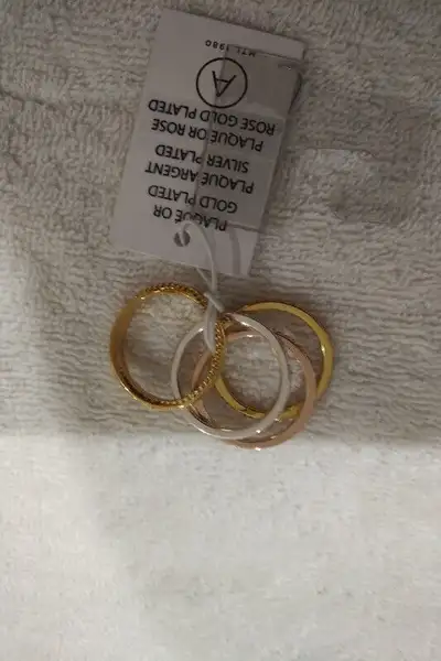 four pretty costume jewelry rings, size 11. Three of the rings have a sparkly 'rhinestone' effect ar...