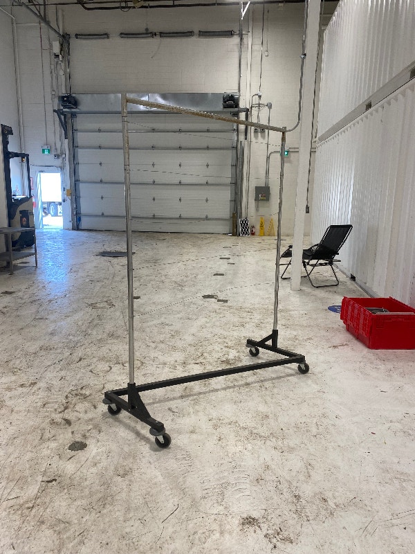 Rolling clothing racks. Solid some rust marks on chrome. Other