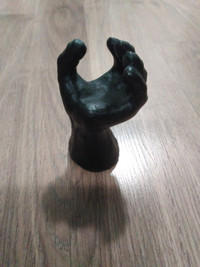A seemingly cast iron half-open hand figurine