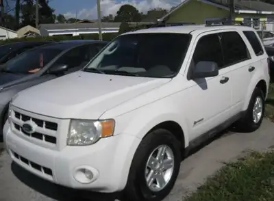 2009 Ford Escape Hybrid AWD with almost new Bridgestone winter tires and summer tires on rims. Bremb...