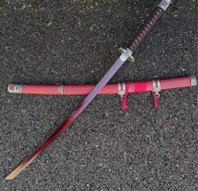 This is a new decorative katana sword featuring a distinctive red scabbard and an intricate handle d...